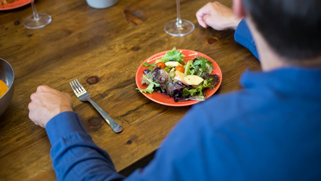 A glass of water on a restaurant table after a meal