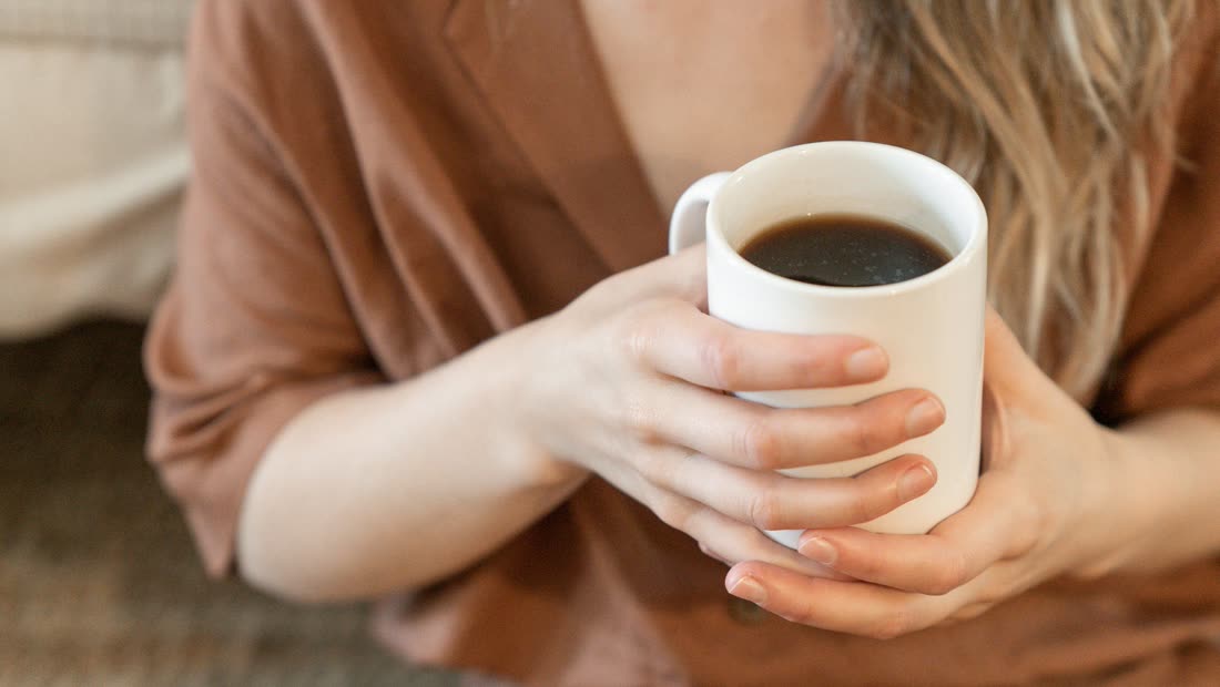 Hands around a mug during a calmer pause