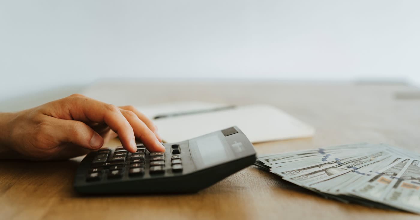 A calculator and money for the yearly cost of cigarettes
