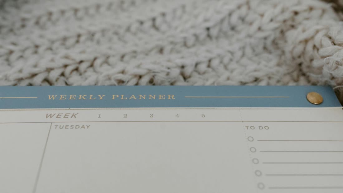 A weekly planner on a soft surface, representing a simple first-week quit-smoking plan