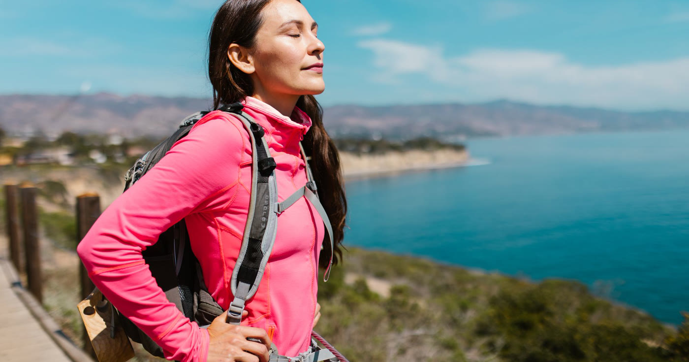 A person breathing in fresh air on a coastal trail