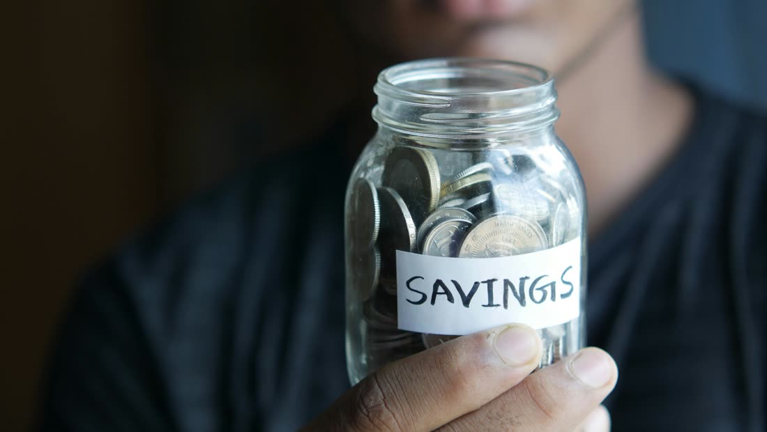 A wallet and coins showing small daily savings