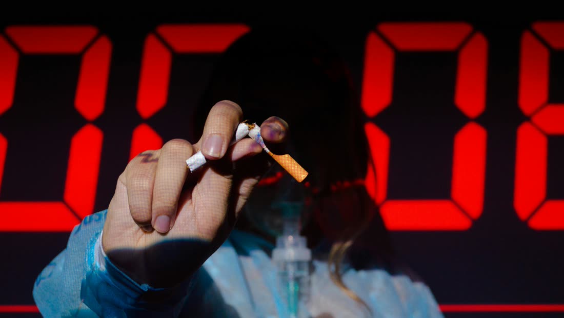 A hand holding a broken cigarette after a slip