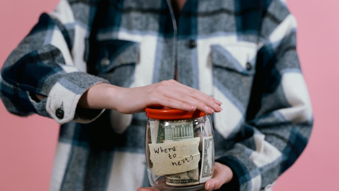 A savings jar with cash set aside as a concrete reward for cigarette savings